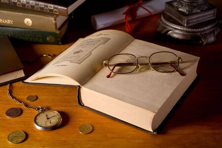 Still-life with books, glasses, and watchesの写真素材