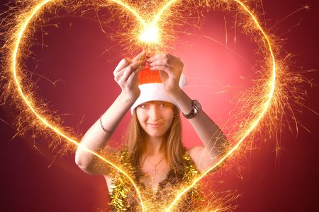 Attractive girl drawing burning heart の写真素材