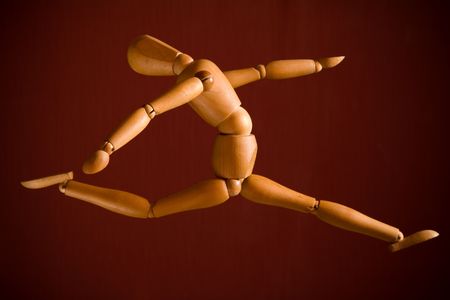 Flying wooden puppet over red background  の写真素材