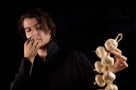 Aristocratic vampire doesnt like the smell of garlic, isolated on black background の写真素材