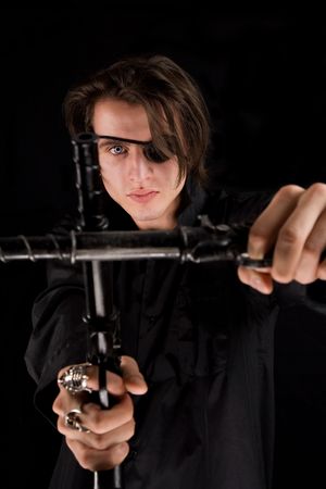 Handsome pirate with eye-patch and scary eye crossing the guns, Halloween theme の写真素材