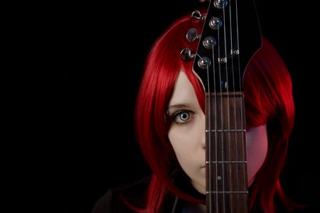 Gothic girl wearing scary lenses with guitar, selective focus on guitar, copyspace for your text  の写真素材