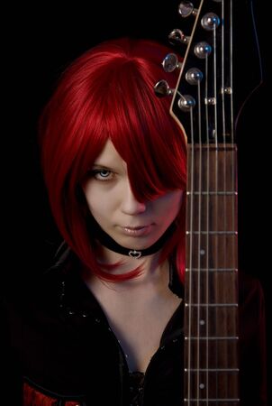 Sexy vampire girl with guitar, focus on face の写真素材