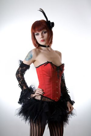 Cabaret girl in red corset, studio shot over light background の写真素材