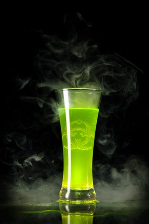 Green radioactive alcohol with biohazard symbol inside, isolated on black background の写真素材