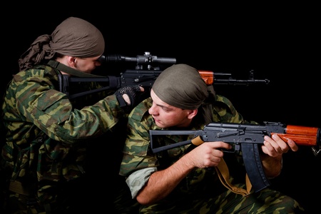 Two soldiers in camouflage uniform, isolated on black background の写真素材