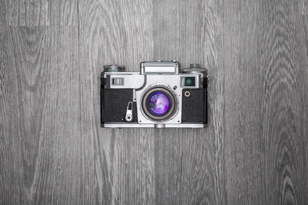 Old retro camera on grey wooden background の写真素材