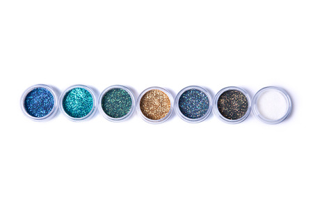 Set of bright glitters in jars, top view isolated on white background