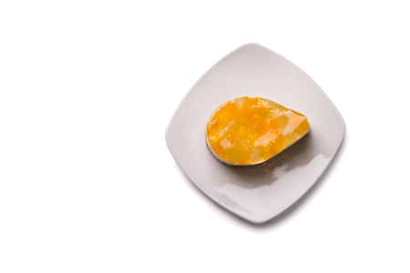 Cake with fruit jelly on plate, top view isolated on white background, clipping path