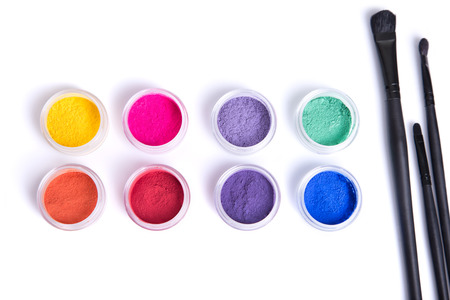 Top view of matte mineral eye shadows and makeup brushes, isolated on white backgroundの写真素材