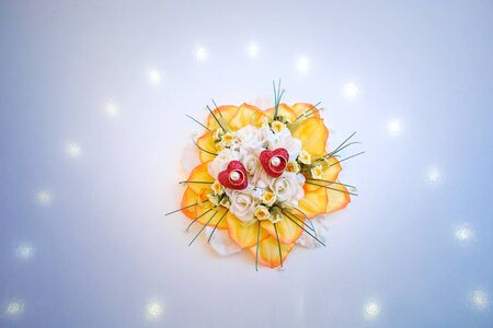 Two gold wedding rings and small flowersの写真素材