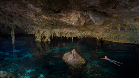 Cenote Dos Ojos with clear blue waterの写真素材