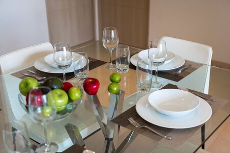 Room with table serving fruits and dishes