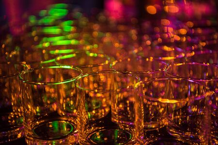 Glasses on a table during a banquet in the open air at nightの写真素材