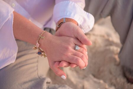 Female palm in a bracelet and with a ring in the male palm.の写真素材