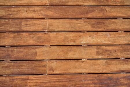 Wooden brown floor with a large horizontal board texture.
