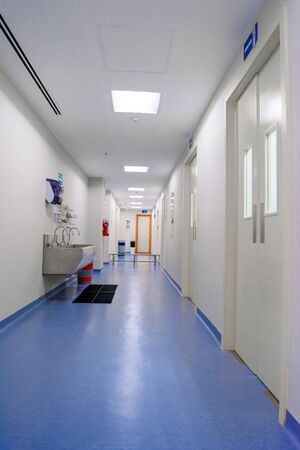 Corridor in the hospital in front of the operating room with a sanitary unit Blue floor.の写真素材