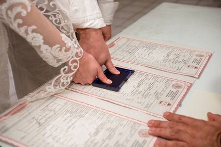 The bride and groom put fingerprints on the wedding certificate. Mexica.の写真素材