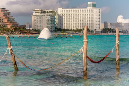 Hammocks hang on poles in the Caribbean.の写真素材