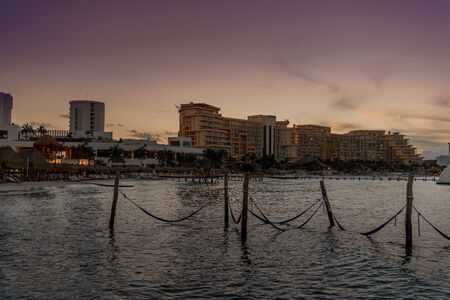 Hammocks hang on poles in the Caribbean.の写真素材