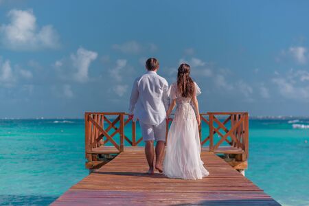 A man and a woman walk on the pier by the sea.の写真素材
