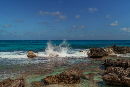 The coastline of the Caribbean Sea with white sand and rocks in Cancun.の写真素材