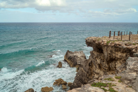 The coastline of the Caribbean Sea with white sand and rocks in Cancun.の写真素材