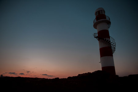 Lighthouse at sunset overlooking the Caribbean sea and sky