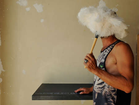 man with face hidden by feathersのeditorial素材