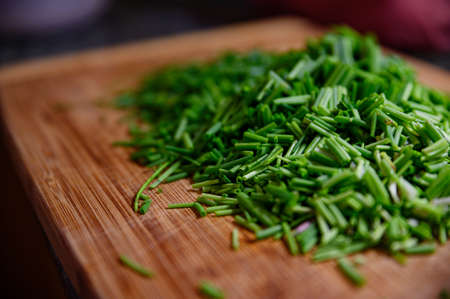 Fresh green chive chopped on wooden tableの写真素材