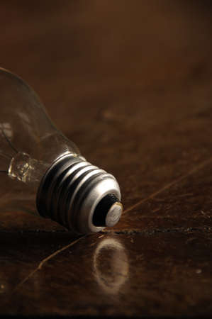 Still life of light bulb on wooden table.