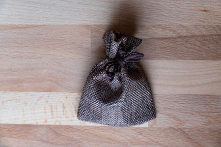 Rustic vintage jute bag on wooden background.の写真素材