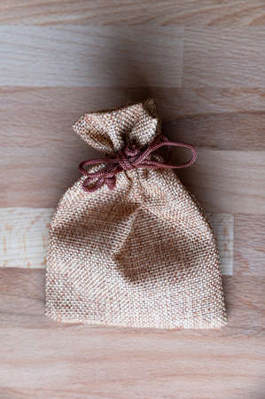 Rustic vintage jute bag on wooden background.の写真素材