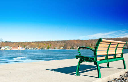 Lakeside bench on a mild winter dayの写真素材