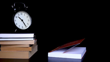 Back to school background with alarm clock, books and note paperの写真素材