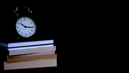 Back to school background with alarm clock, books, apple and pencils. Note paper, alarm clock, pen and pencil.の写真素材
