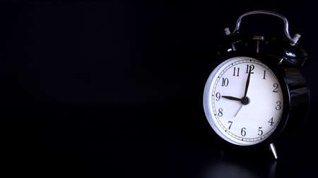 Close up image of old black vintage alarm clock. Time management and deadline urgency concept. 9 o'clockの写真素材