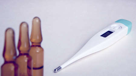 Pharmacy theme, ampoules with vitamin C and thermometer. Medicine background for medical concept....