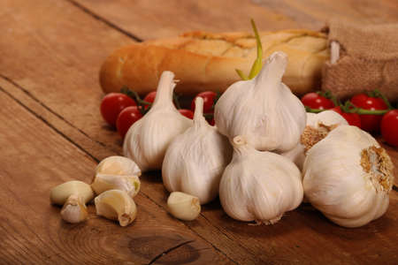 Tasty bread with Garlic. sliced garlic, garlic clove, garlic bulb, Small red cherry tomatoes on...