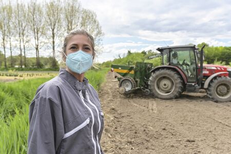 Female worker and his protective mask against covid-19の写真素材