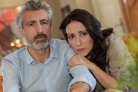 middle-age couple watchs TV news  during Covid 19