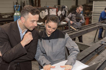 Female worker is trying to convince her boss of her developmentの写真素材