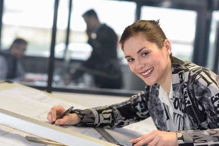 draftwoman works on a drawing in a design officeの写真素材