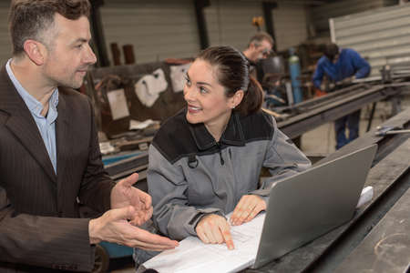 Female worker is trying to convince her boss of her developmentの写真素材
