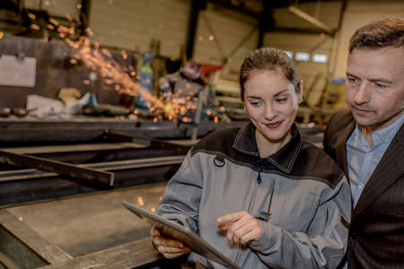 Happy male engineer and female supervisor showing and ok and thumbs up sighの写真素材