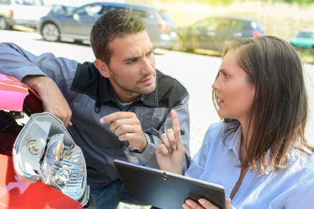 Expert checks the cost of a car reparationの写真素材