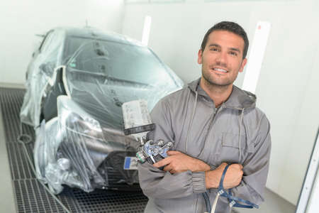 Portrait of a car body painter in his paint boothの写真素材
