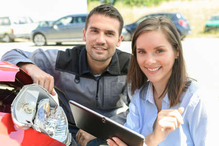 Expert checks the cost of a car reparationの写真素材