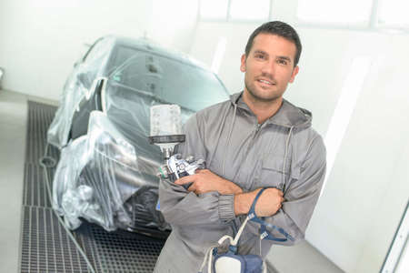 Portrait of a car body painter in his paint boothの写真素材
