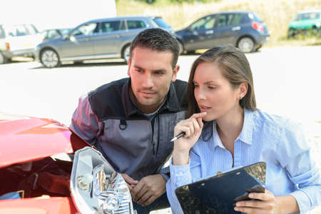 Expert checks the cost of a car reparationの写真素材
